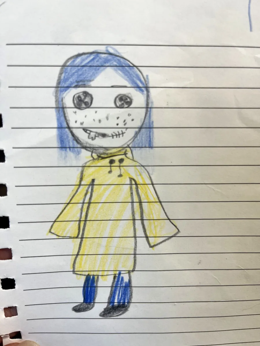 The daughter's pencil and crayon drawing of a girl with blue hair and a yellow coat