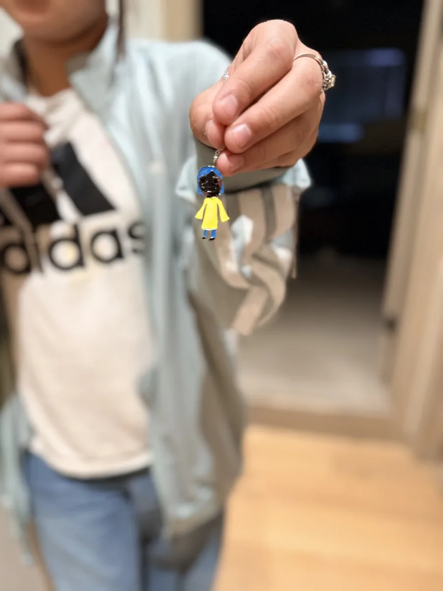 The colourful necklace held up by its chain